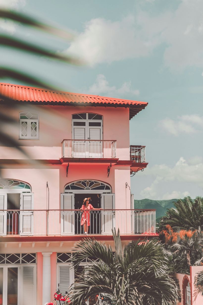 Lady traveller enjoying her view from her hotel balcony