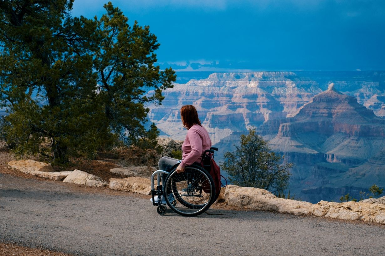 Lady in her wheelchair enjoying the view of the distant mountains