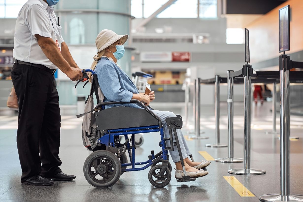 Lady in wheelchair ready to travel at airport