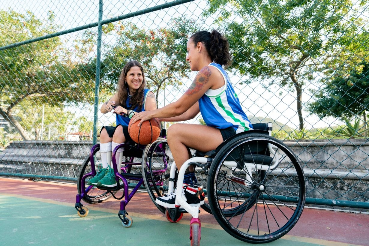 Two disabled women having fun with basketball